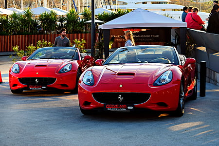 two red Maserati convertible coupe parked near people thumbnail