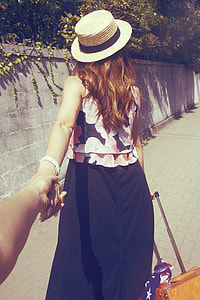 woman wearing black and pink dress and beige fedora hat thumbnail