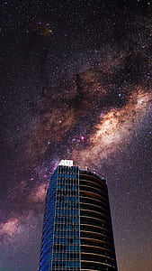 blue and black building under starry sky thumbnail
