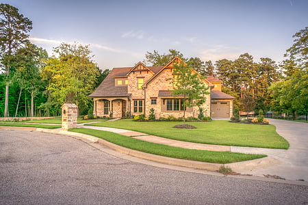 brown concrete house with green lawn thumbnail