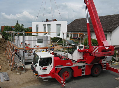 red and white mobile crane fixing house thumbnail