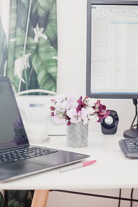 black laptop computer on white table near black desktop set thumbnail