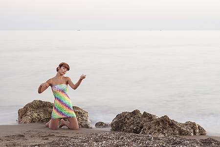 Woman Kneeling Beside Rock thumbnail