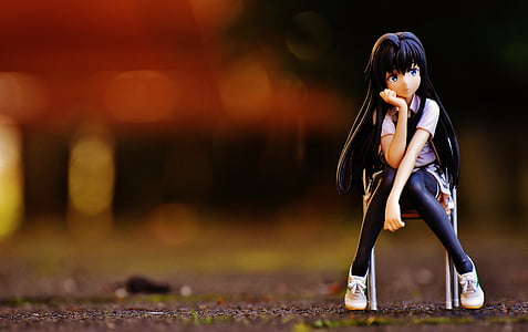 selective focus photography of woman sitting on chair action figure thumbnail
