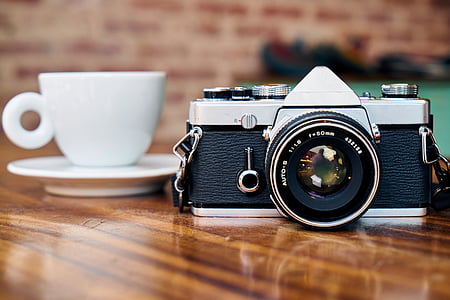 panoramic photography of DSLR camera in front of teacup and saucer thumbnail
