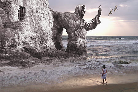 woman standing on shore near statue thumbnail