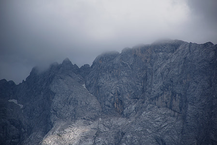rock mountains under white clouds during daytime thumbnail