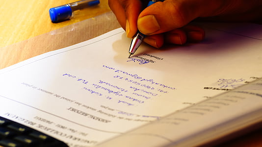 person writing on white paper thumbnail