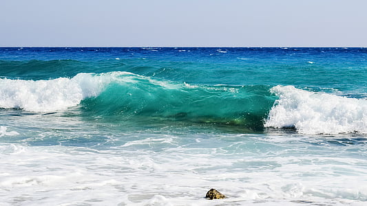 body of water crashing on rock during daytime thumbnail