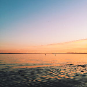 silhouette of sailboat and people on sea during sunset thumbnail