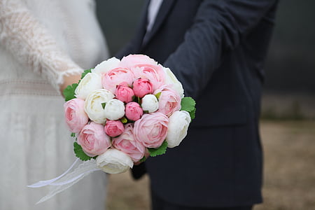 bride and groom holding pink and white flower bouquet thumbnail