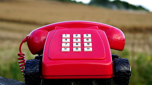 red and white corded telephone thumbnail
