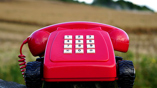 red telephone selective focus photography thumbnail