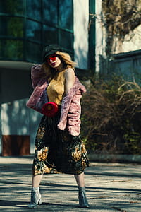 Woman Standing Wearing Pink Coat thumbnail