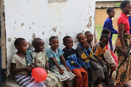 group of children sitting beside wall thumbnail