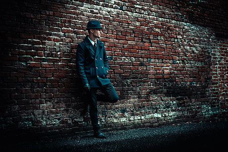 man leaning on wall thumbnail