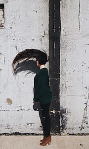 time-lapse photo of woman standing while flipping her hair thumbnail