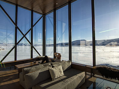 man sitting on couch beside the window thumbnail