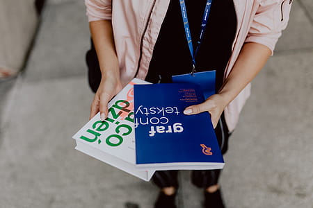 The woman is holding books in her hands thumbnail