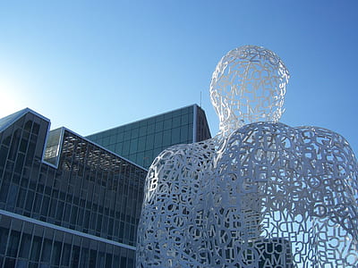 low-angle photo of grey glass building under blue sky thumbnail