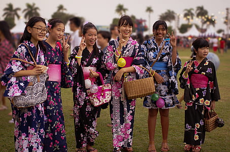group of woman standing on grass field thumbnail