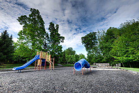 blue and brown slide set under blue cloudy skies thumbnail