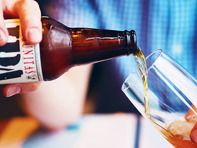 person holding wine bottle and drinking glass thumbnail