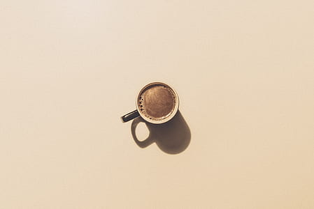 black ceramic coffee cup with brown liquid thumbnail