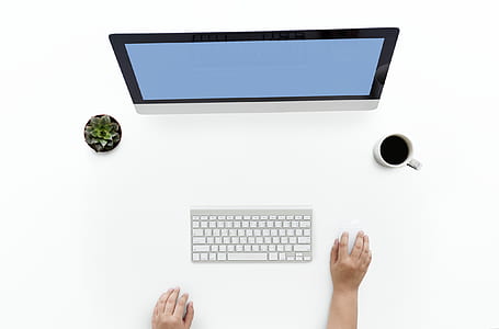 turned-on flat screen computer monitor and Apple Magic keyboard thumbnail