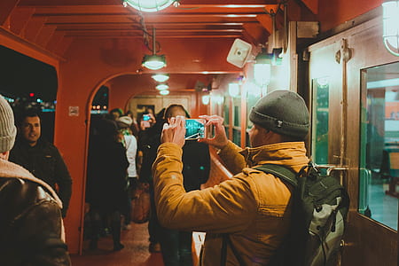 man taking a photo of people inside ship's aisle thumbnail