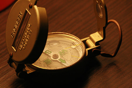 unfold compass on brown wooden surface thumbnail