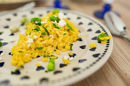 Risotto with broad bean on a cute plate with blue hearts thumbnail