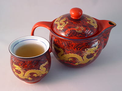 red and brown dragon print teacup beside teapot thumbnail