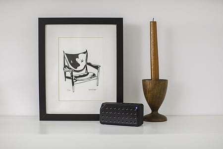 brown candle with holder beside photo frame on table thumbnail