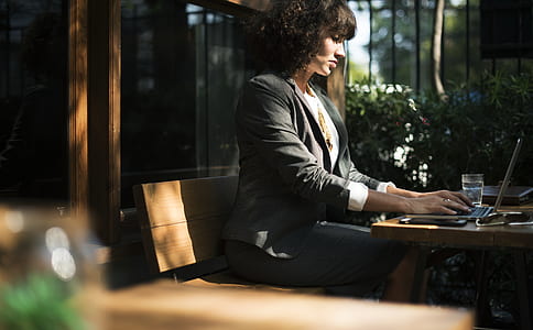 woman sitting on bench using laptop thumbnail