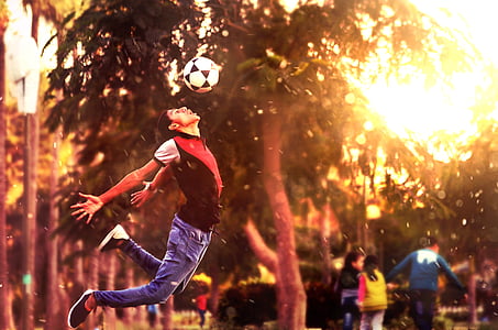 person playing soccer during sunset thumbnail