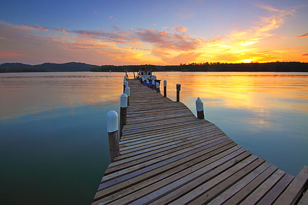brown wooden dock during golden hour thumbnail