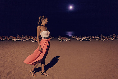 woman wearing tube maxi dress standing near lounge chairs thumbnail