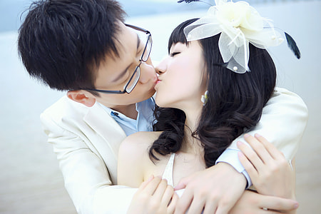 man and woman kissing and while hugging near ocean at daytime thumbnail