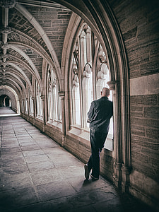 man in grey shirt and blue pants inside brown wall building thumbnail