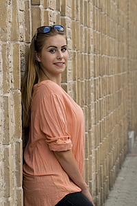 woman leaning against wall thumbnail