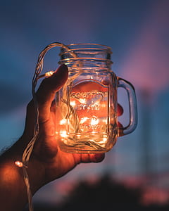 person holding clear mason jar thumbnail