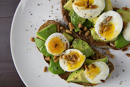 Soft-boiled eggs and avocado on toasted walnut bread thumbnail