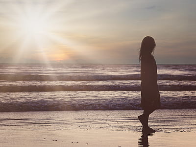 girl silhouette on seashore photo thumbnail
