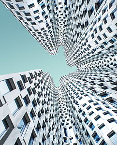 low-angle photo of gray building taken during daytime thumbnail
