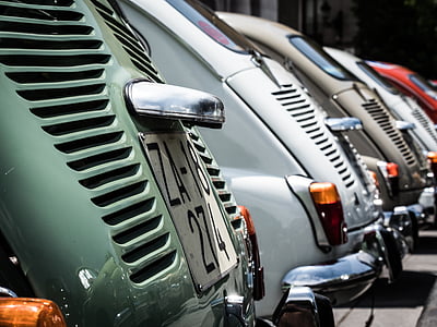 assorted-color Volkswagen Beetle coupe park in the parking area thumbnail
