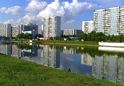 calm body of water beside the buildings thumbnail