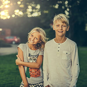 girl and boy near tree thumbnail