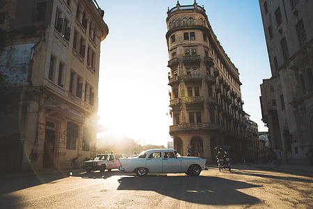 vintage white car in the middle of the road thumbnail