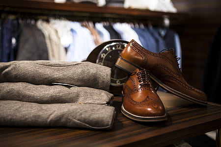 pair of brown leather dress shoes on brown wooden table thumbnail
